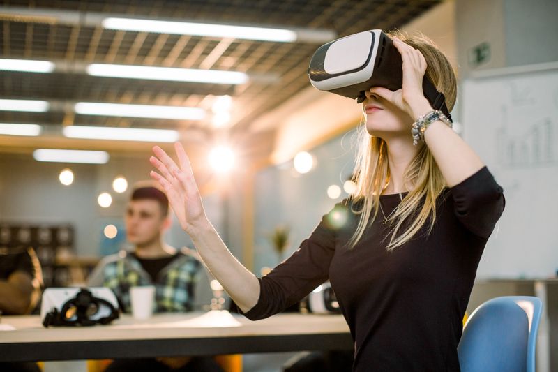 Woman using VR headset in office