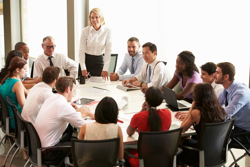 Group of people sitting around a table at the office