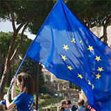 Image of young woman flying the EU flag